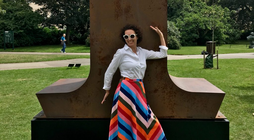 Louise in front of a large scale Corten steel number 1
