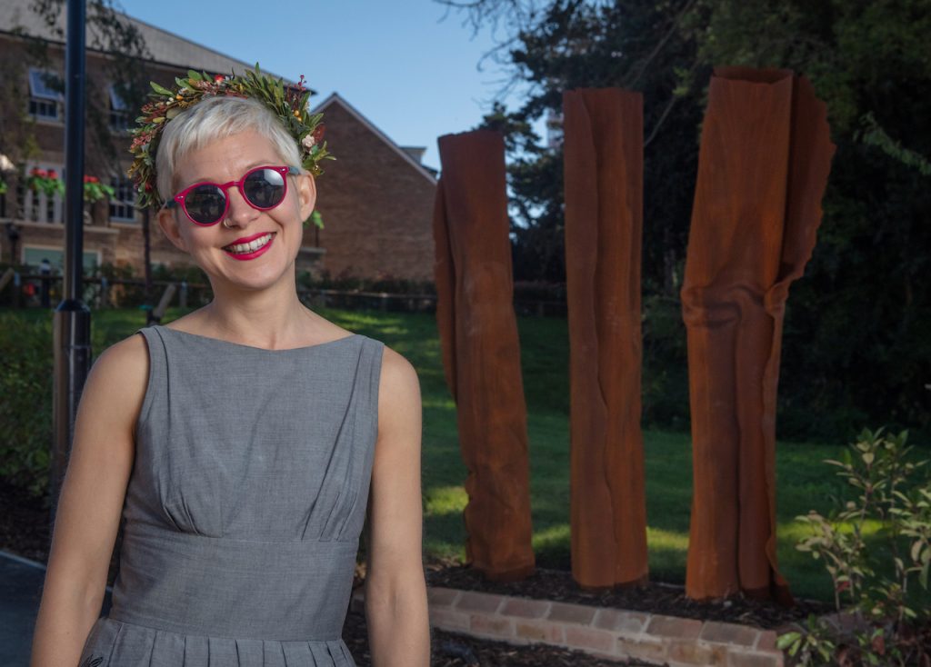 Kerry Lemon smiling in front of sculptures