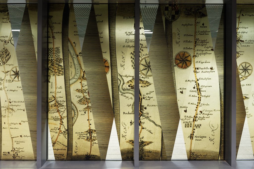 Detail of medieval maps displayed on glass partition