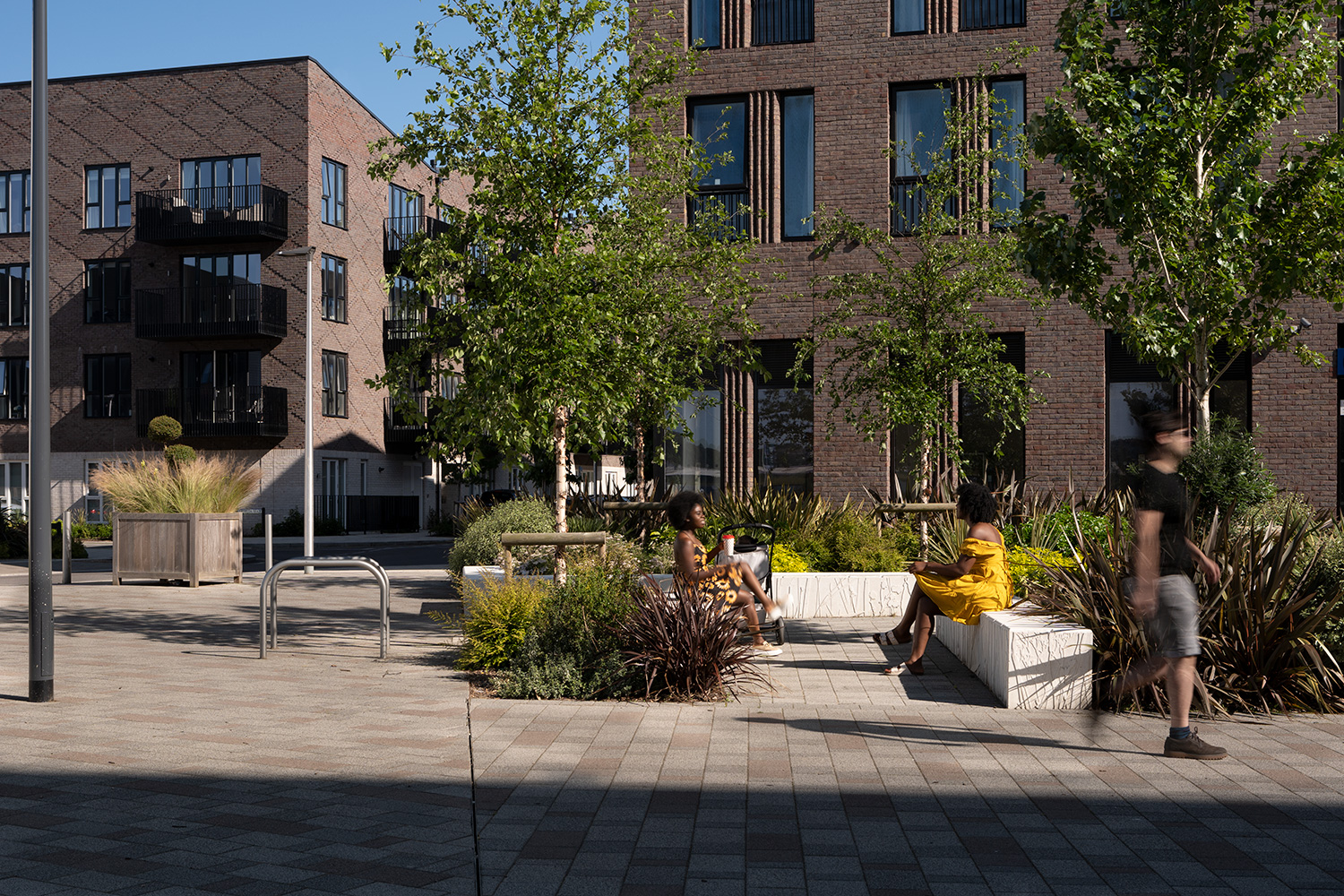 people sitting on benches at Rochester Riverside
